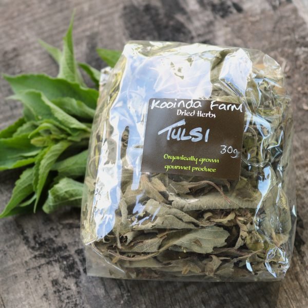 packet of tulsi leaves with some fresh leaves